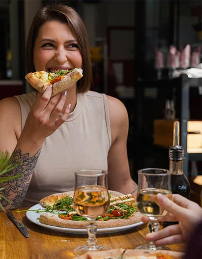 Une cliente se régale avec les pizzas de l'Atelier Lou Gardo